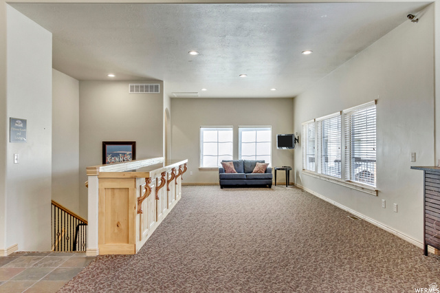3598 North Huntsman Path, Unit 502 Eden, UT 84310 - Photo 27 of 43 Carpeted living area featuring recessed lighting and baseboards