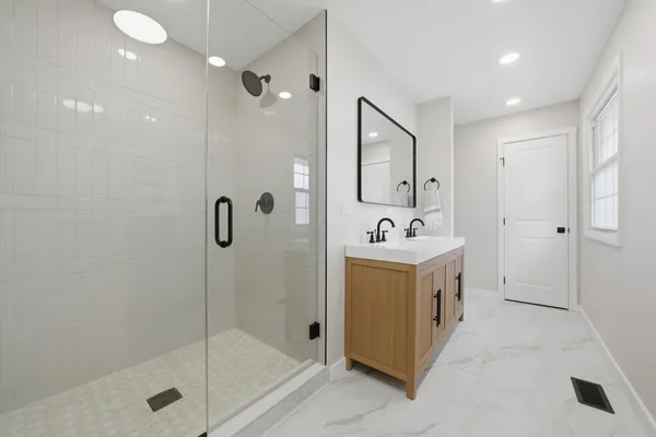 a bathroom with a sink a toilet and shower