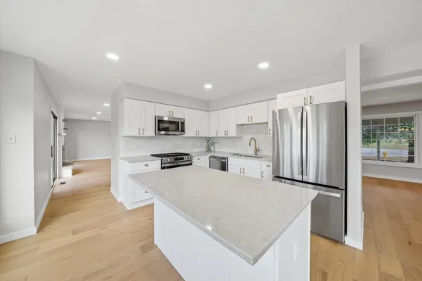 a kitchen with stainless steel appliances a refrigerator stove microwave and cabinets