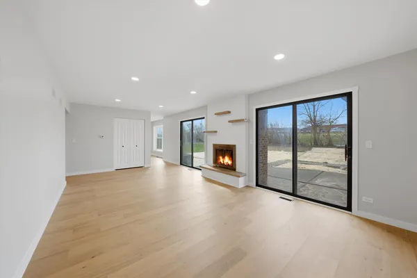 an empty room with fireplace and windows