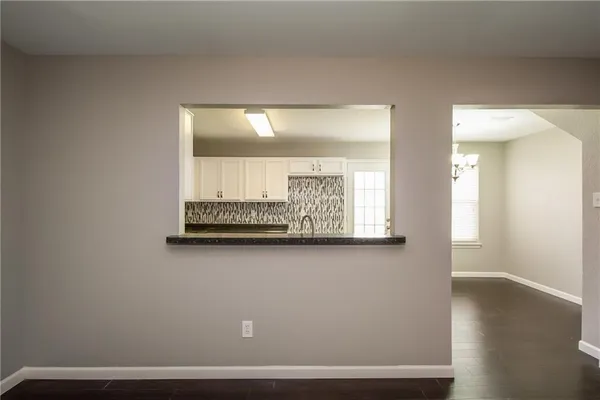 a view of room with window and wooden floor
