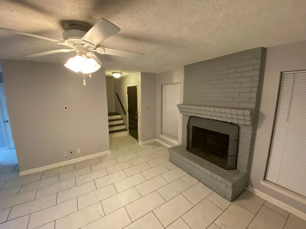 a view of a livingroom with a fireplace and fan