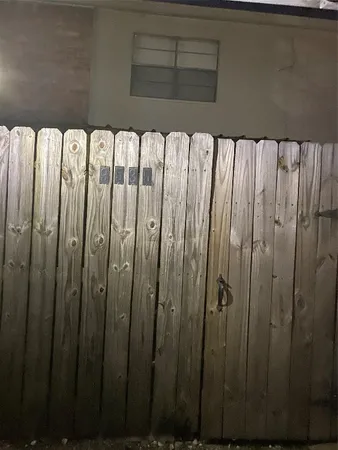 a view of a door with a wooden fence