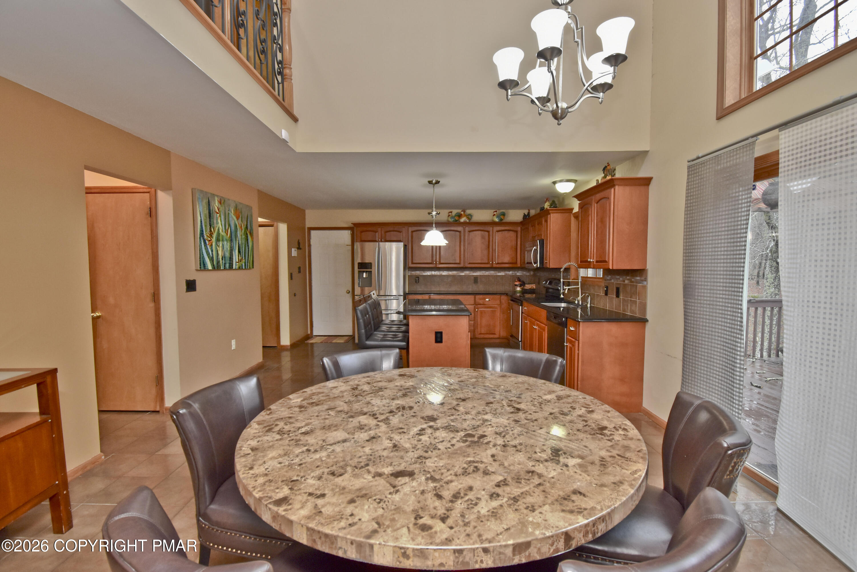 131 Canterbury Road Bushkill, PA 18324 - Photo 11 of 65 a kitchen with stainless steel appliances wooden floor and chandelier