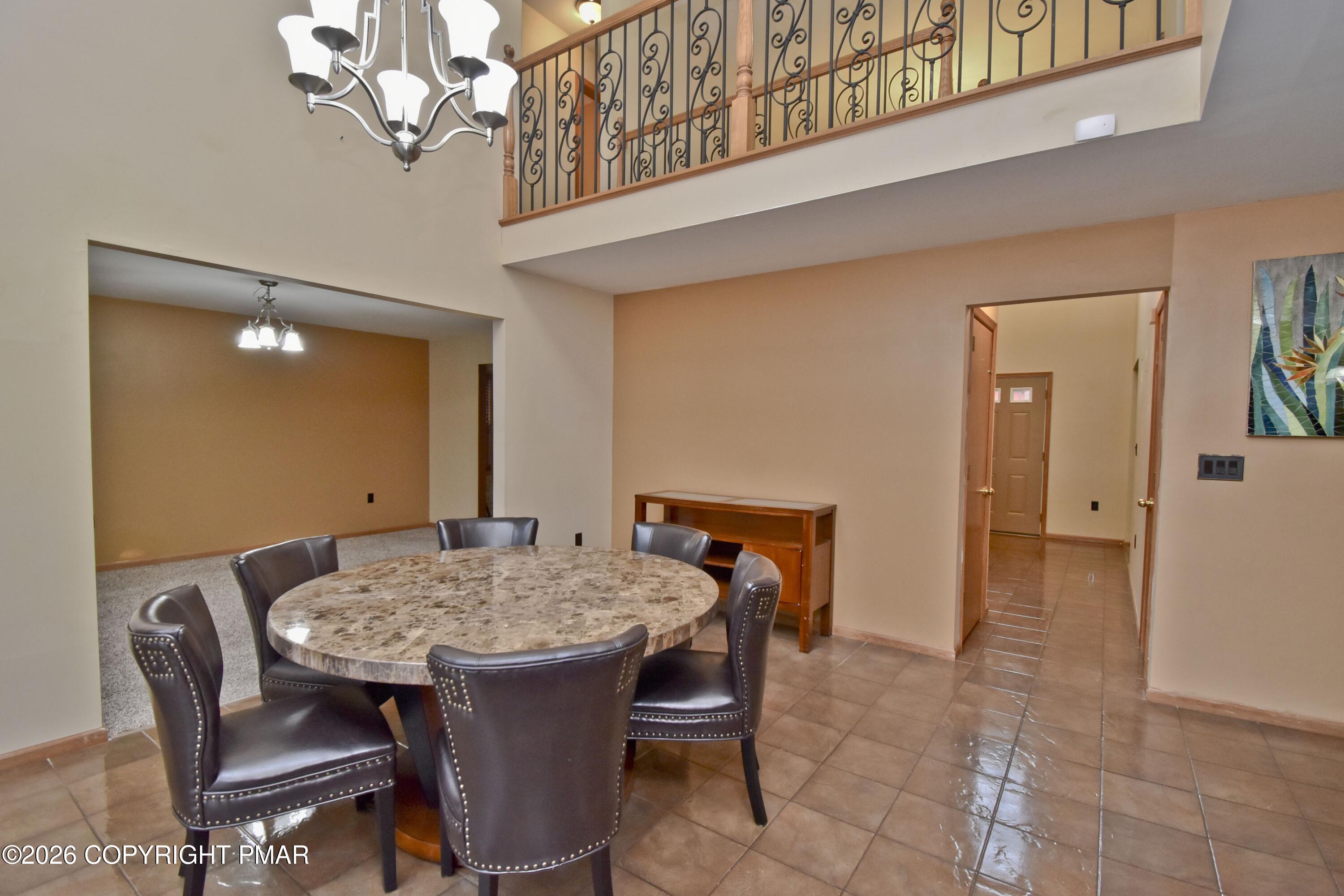 131 Canterbury Road Bushkill, PA 18324 - Photo 13 of 65 a view of a dining room with furniture and a chandelier