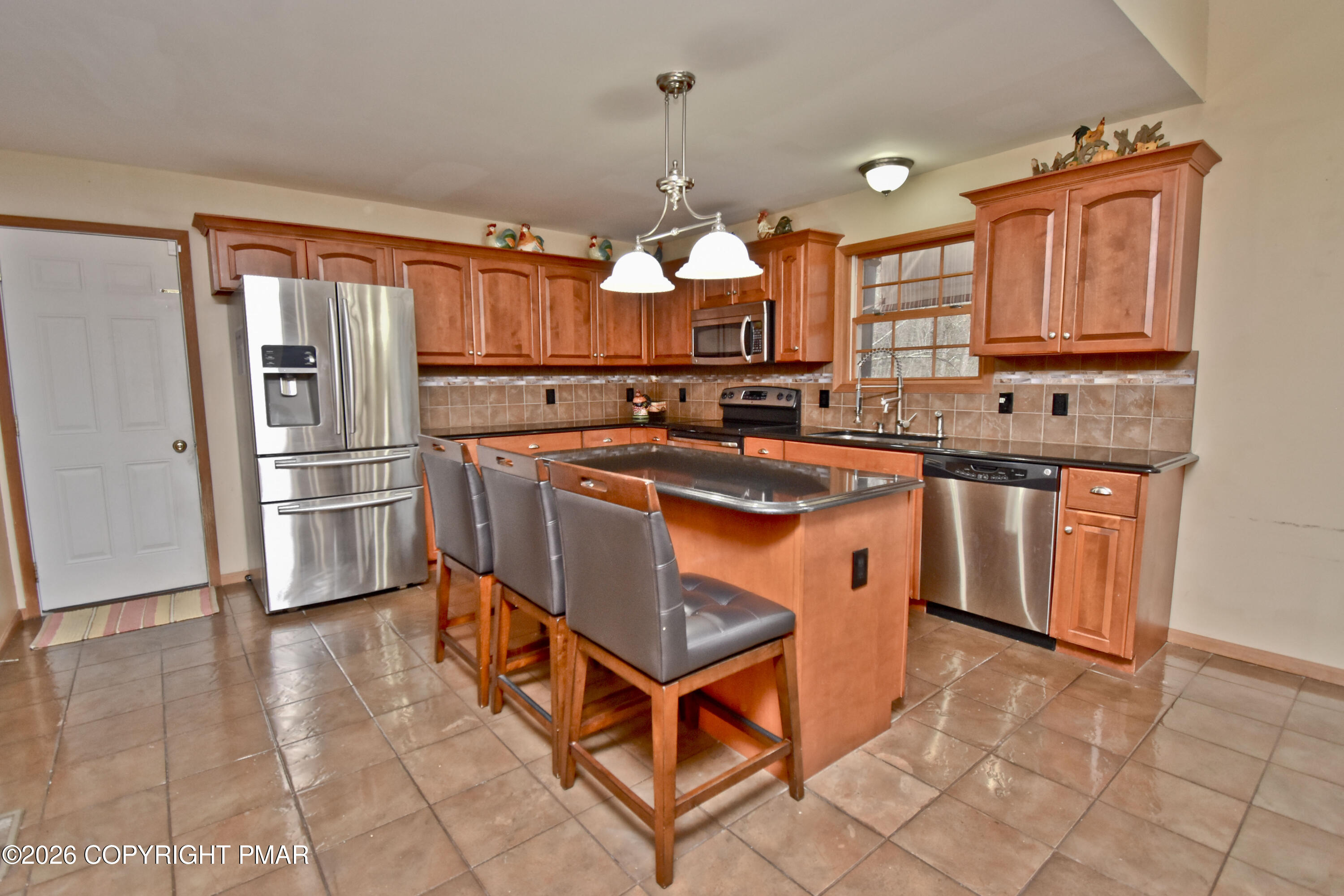 131 Canterbury Road Bushkill, PA 18324 - Photo 15 of 65 a kitchen with stainless steel appliances granite countertop a sink stove and refrigerator