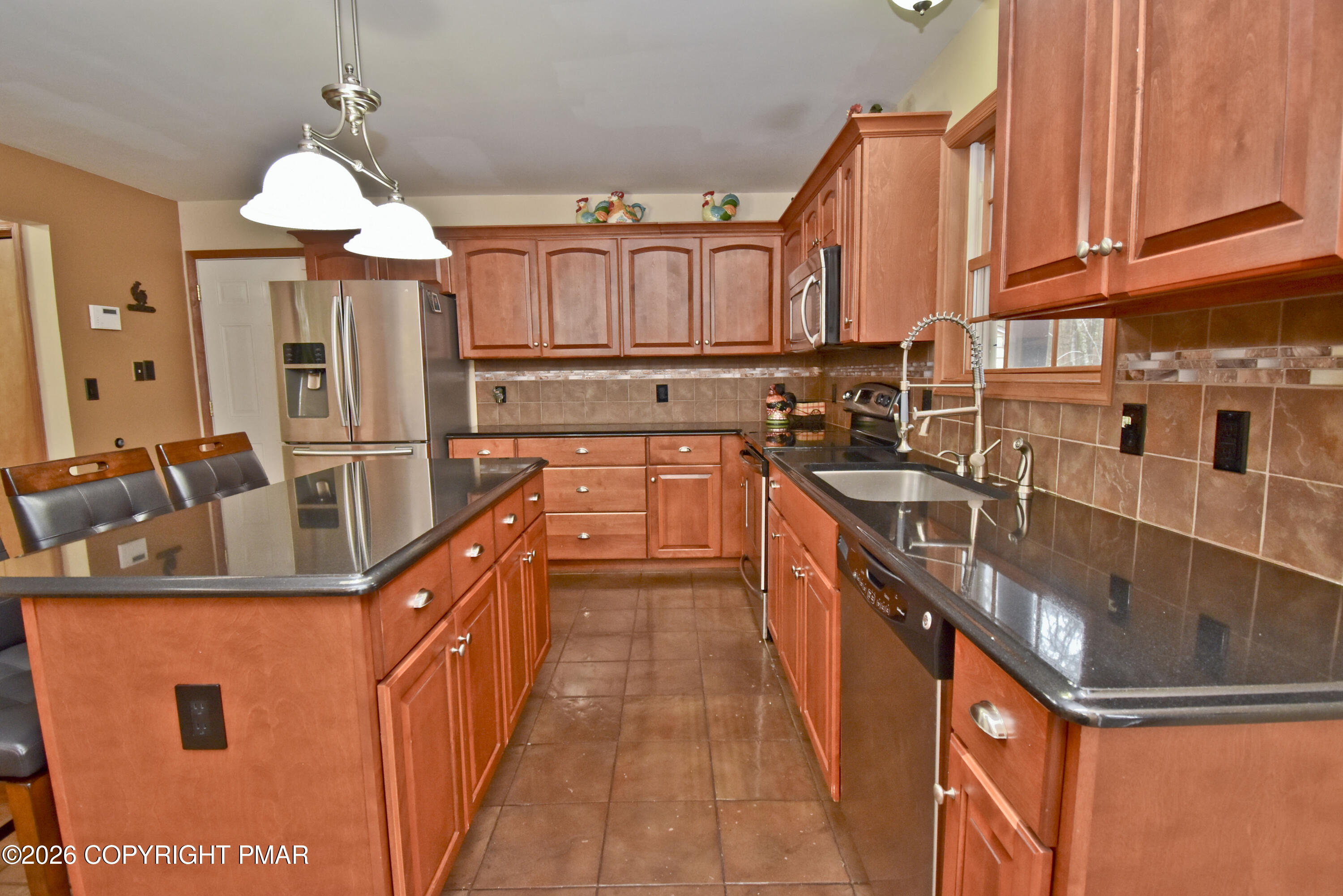 131 Canterbury Road Bushkill, PA 18324 - Photo 16 of 65 a kitchen with stainless steel appliances granite countertop a sink a counter space and a view of living room