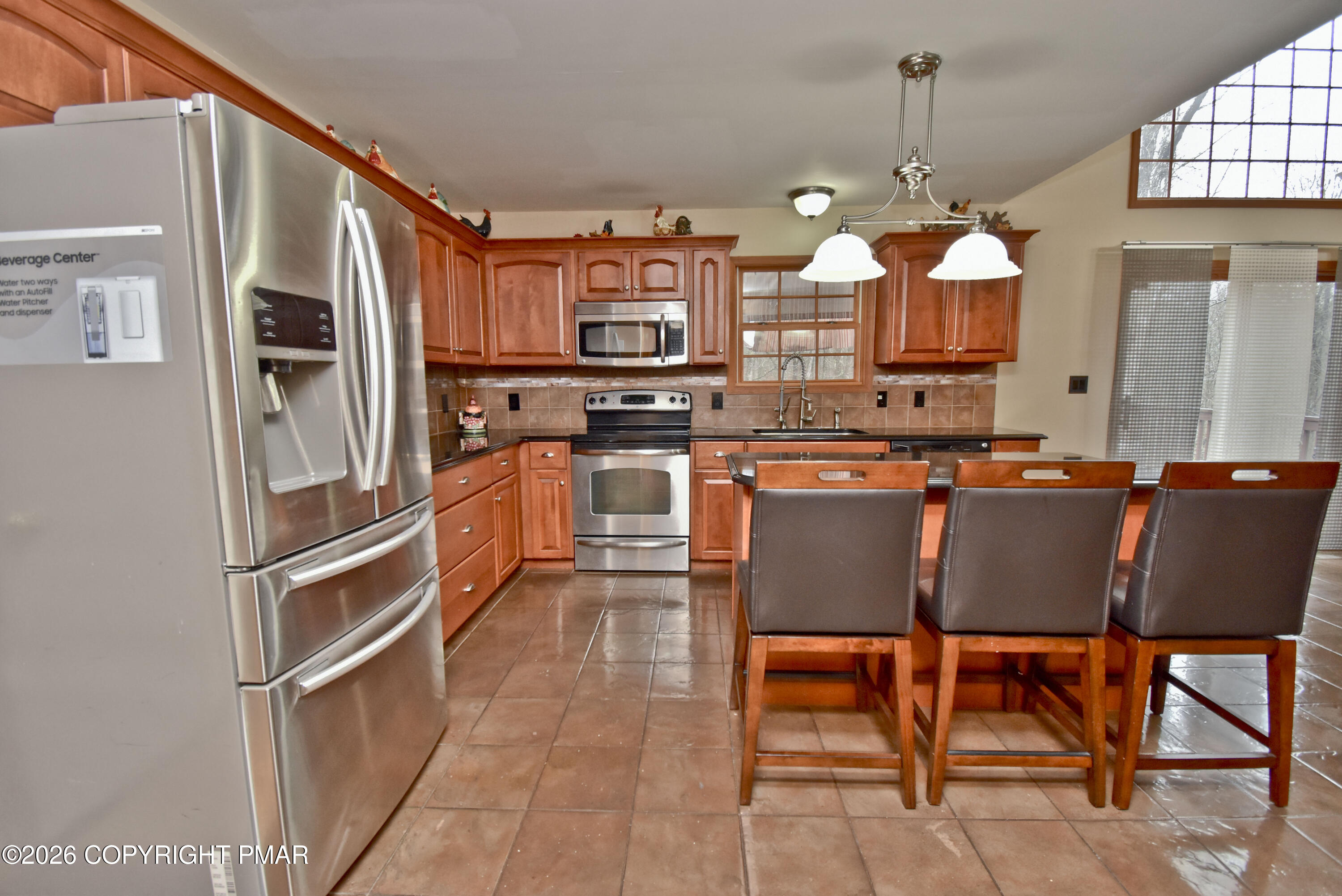 131 Canterbury Road Bushkill, PA 18324 - Photo 17 of 65 a kitchen with stainless steel appliances granite countertop a sink refrigerator and cabinets