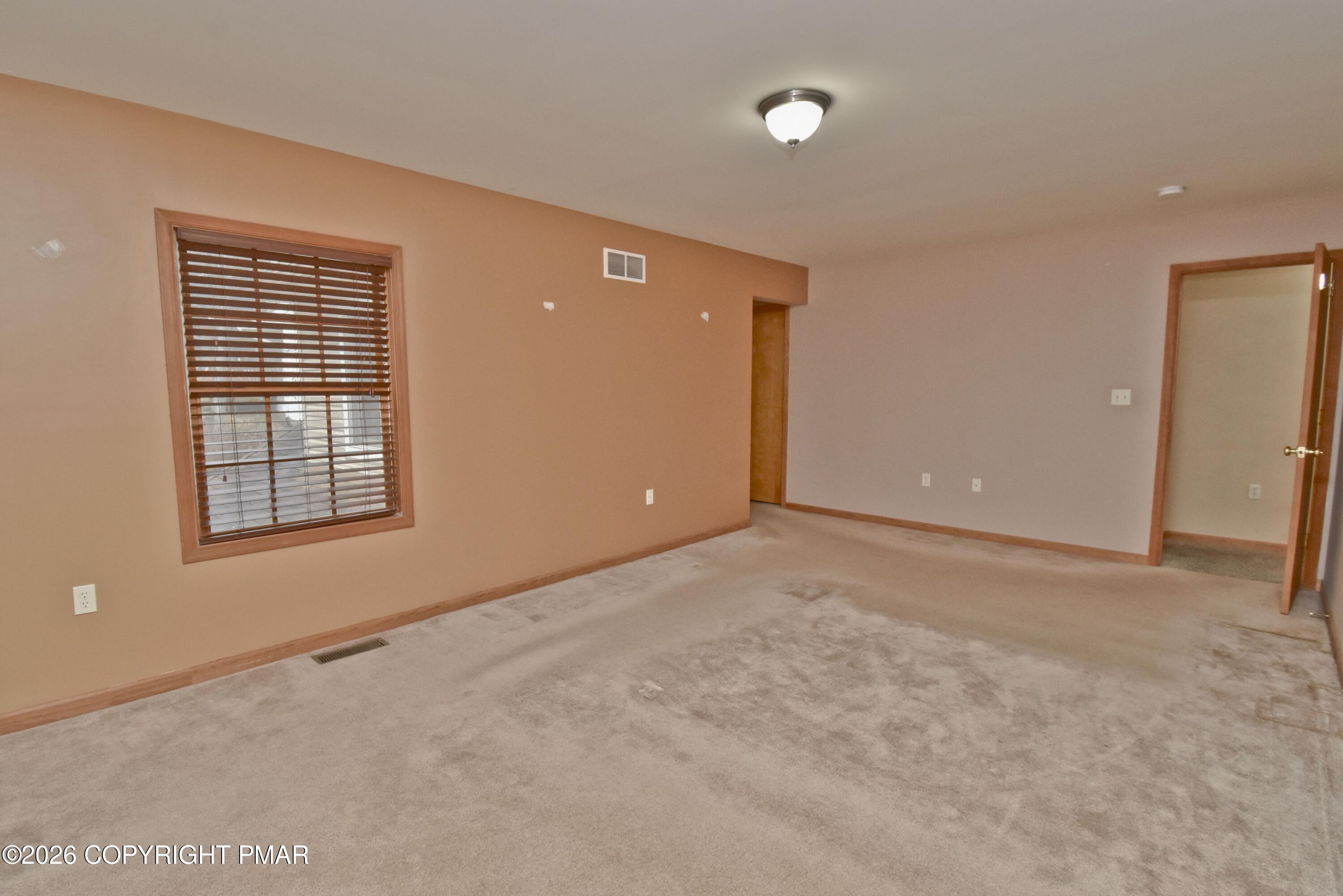 131 Canterbury Road Bushkill, PA 18324 - Photo 27 of 65 a view of an empty room with a window
