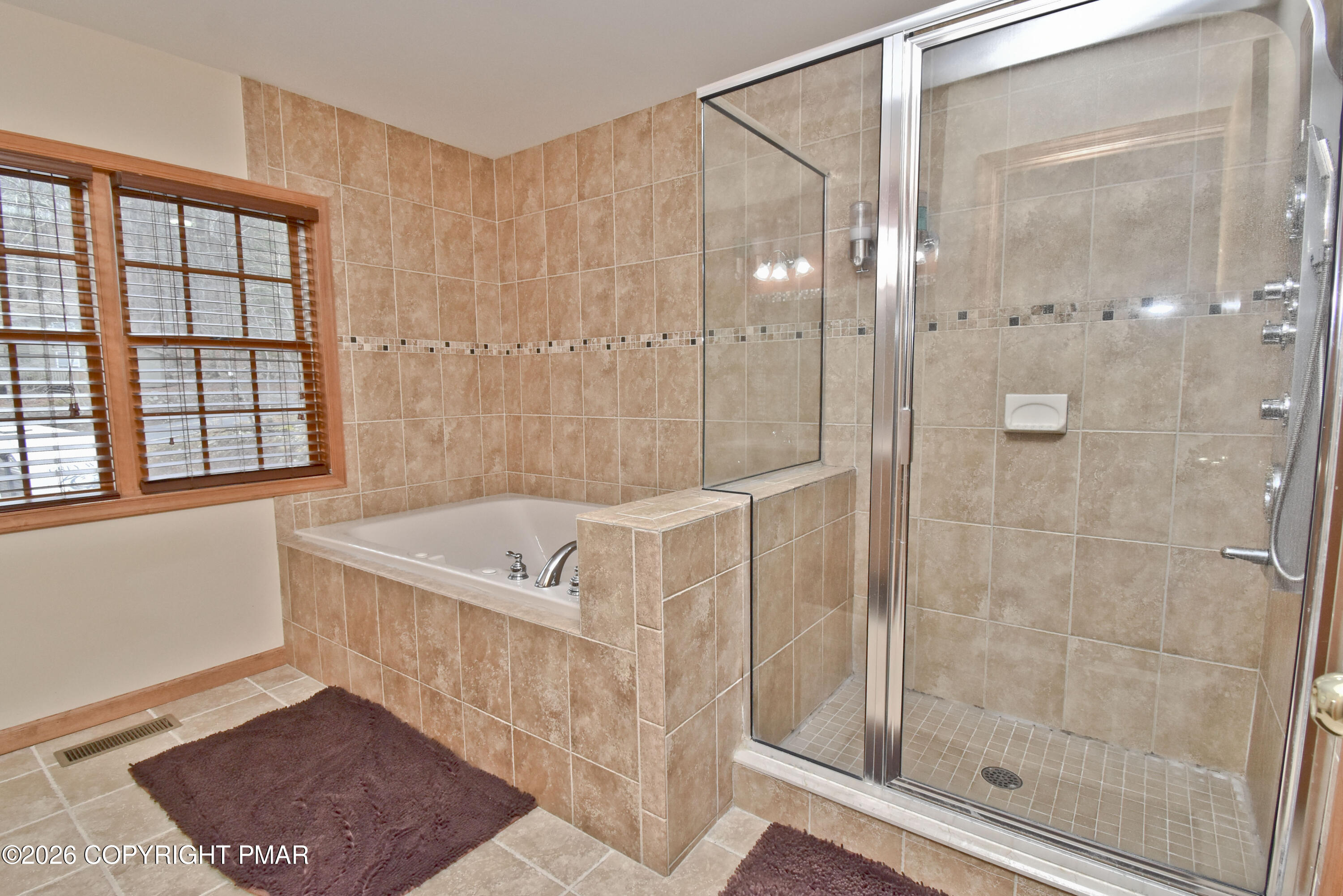 131 Canterbury Road Bushkill, PA 18324 - Photo 28 of 65 a bathroom with a tub a sink and a shower