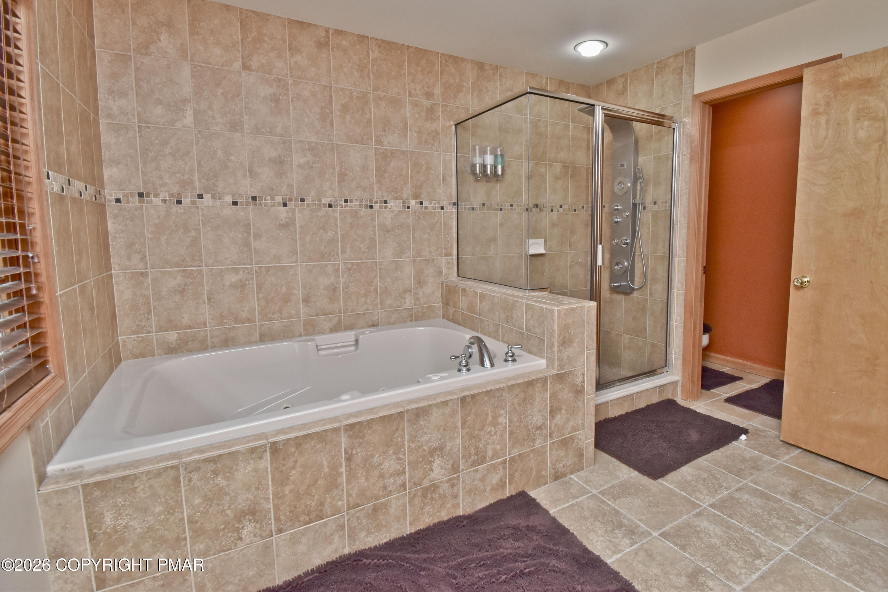131 Canterbury Road Bushkill, PA 18324 - Photo 32 of 65 a bathroom with a large tub shower and checkered floor