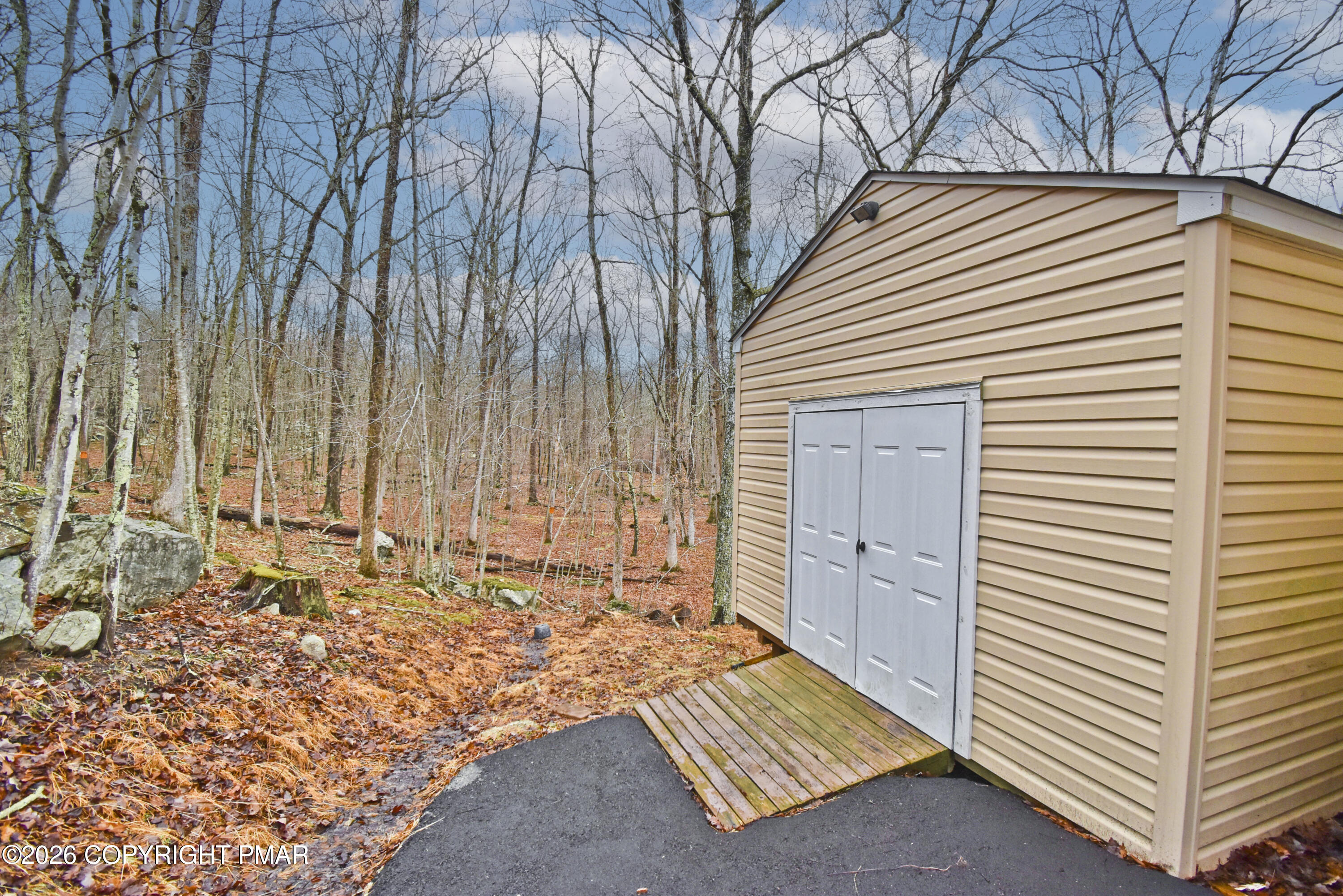 131 Canterbury Road Bushkill, PA 18324 - Photo 47 of 65 a view of a backyard with a chair and table
