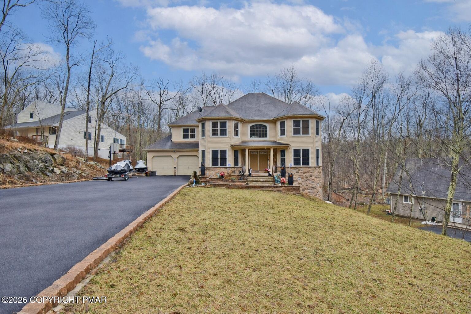 131 Canterbury Road Bushkill, PA 18324 - Photo 51 of 65 a front view of a house with a yard