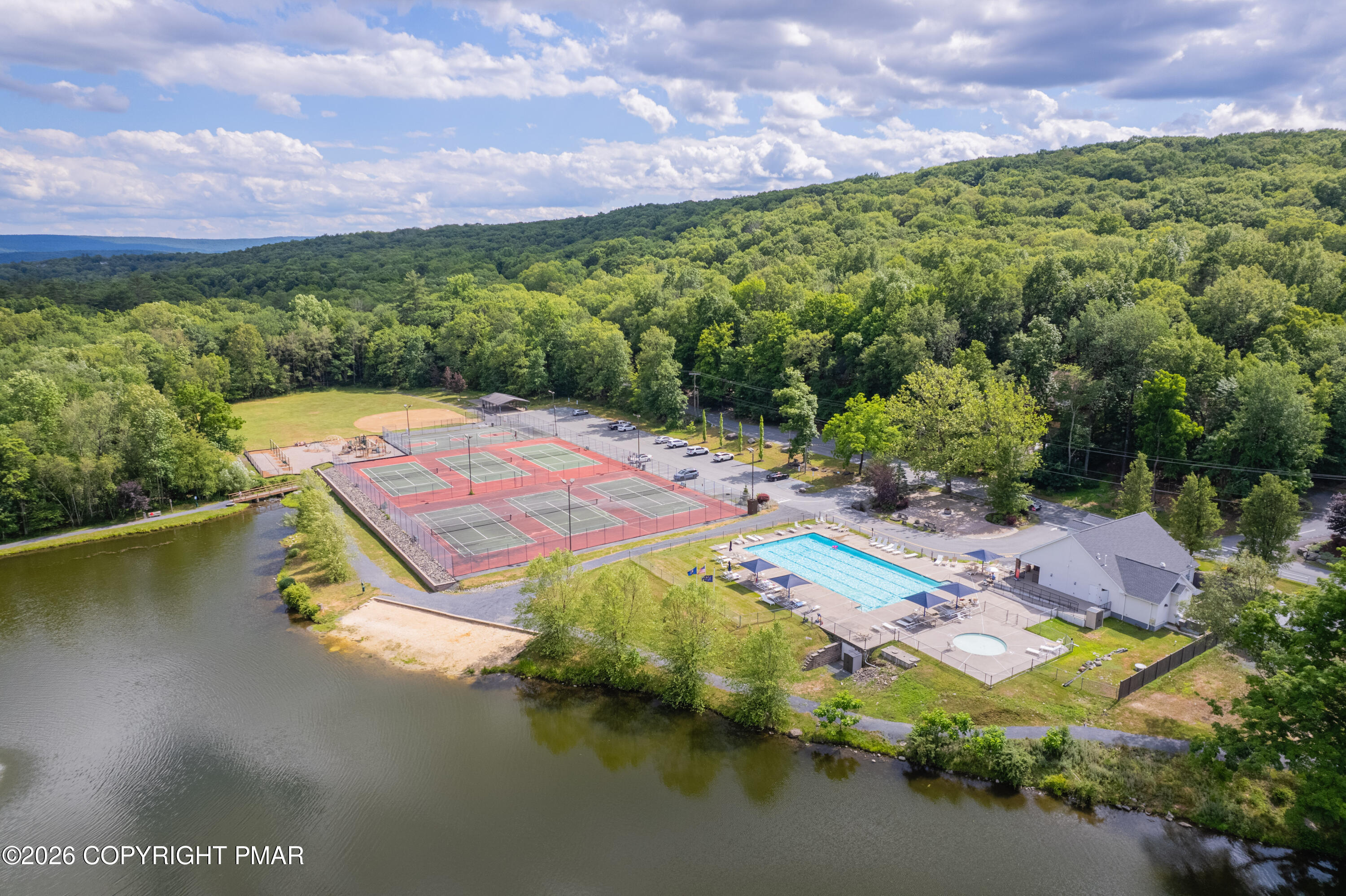 131 Canterbury Road Bushkill, PA 18324 - Photo 56 of 65 a view of a lake with a nearby beach