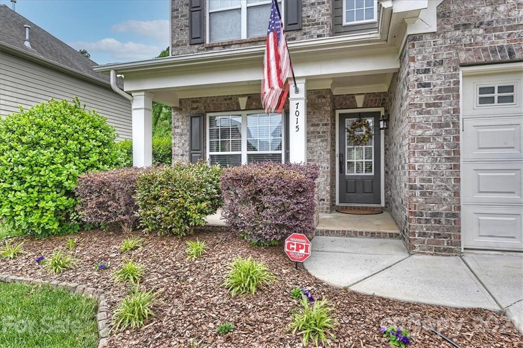 7015 Sedgewick Road Indian Trail, NC 28079 - Photo 3 of 14 a front view of a house with garden
