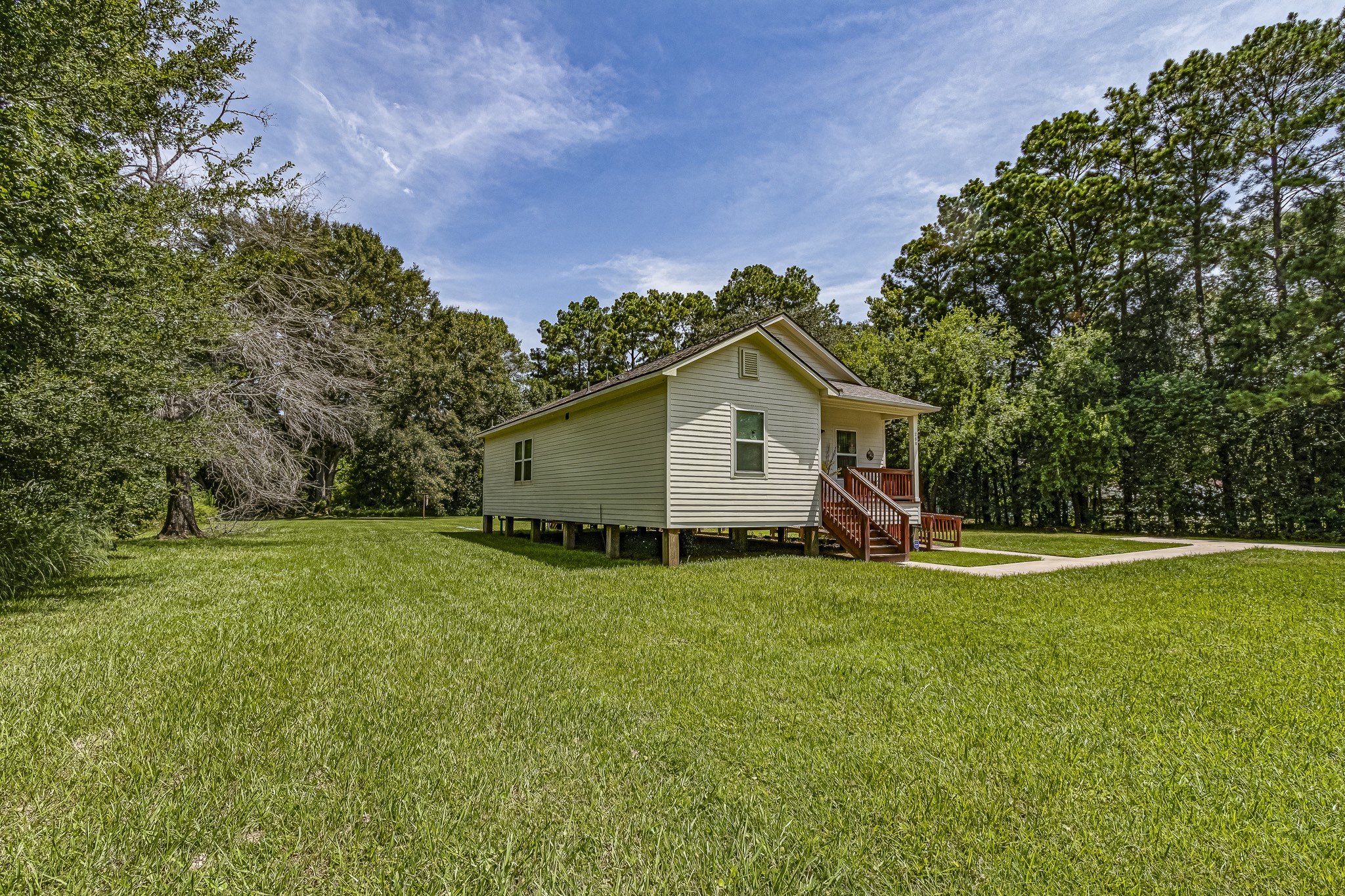 208 County Road 308 Cleveland, TX 77327 - Photo 19 of 32 a view of a house with a yard
