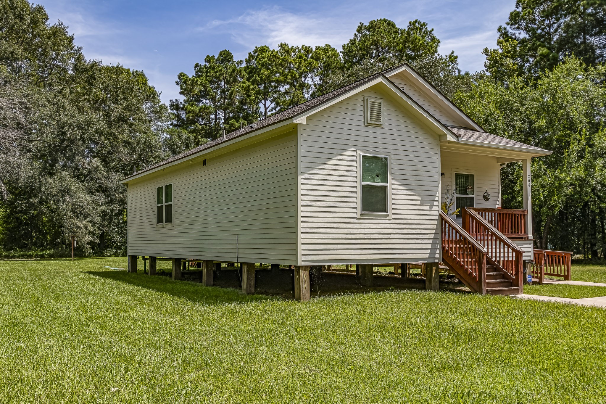 208 County Road 308 Cleveland, TX 77327 - Photo 20 of 32 a view of a house with a yard