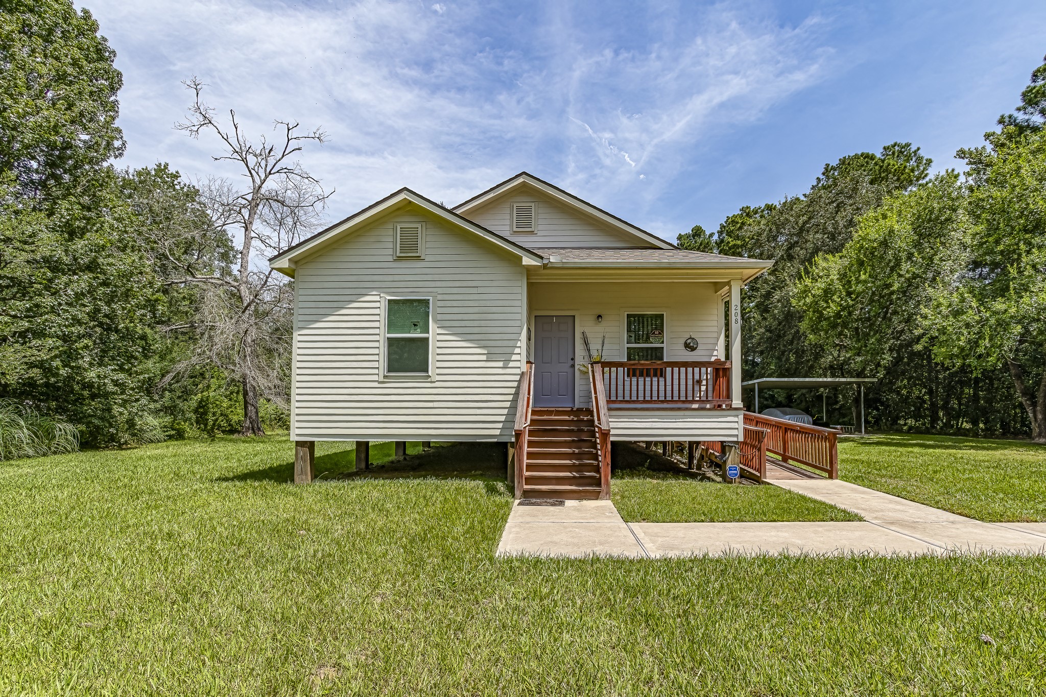 208 County Road 308 Cleveland, TX 77327 - Photo 2 of 32 a view of a house with backyard and garden
