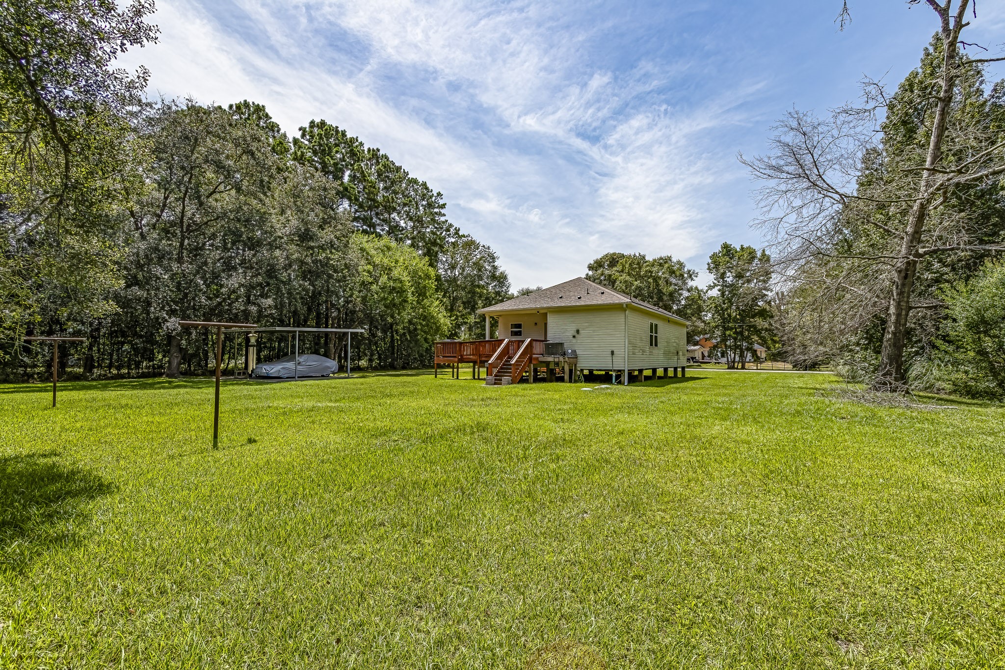 208 County Road 308 Cleveland, TX 77327 - Photo 22 of 32 a view of a house with a yard and basketball court