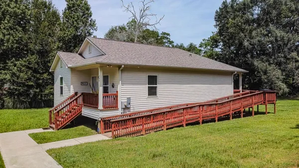 a backyard of a house with wooden floor and fence