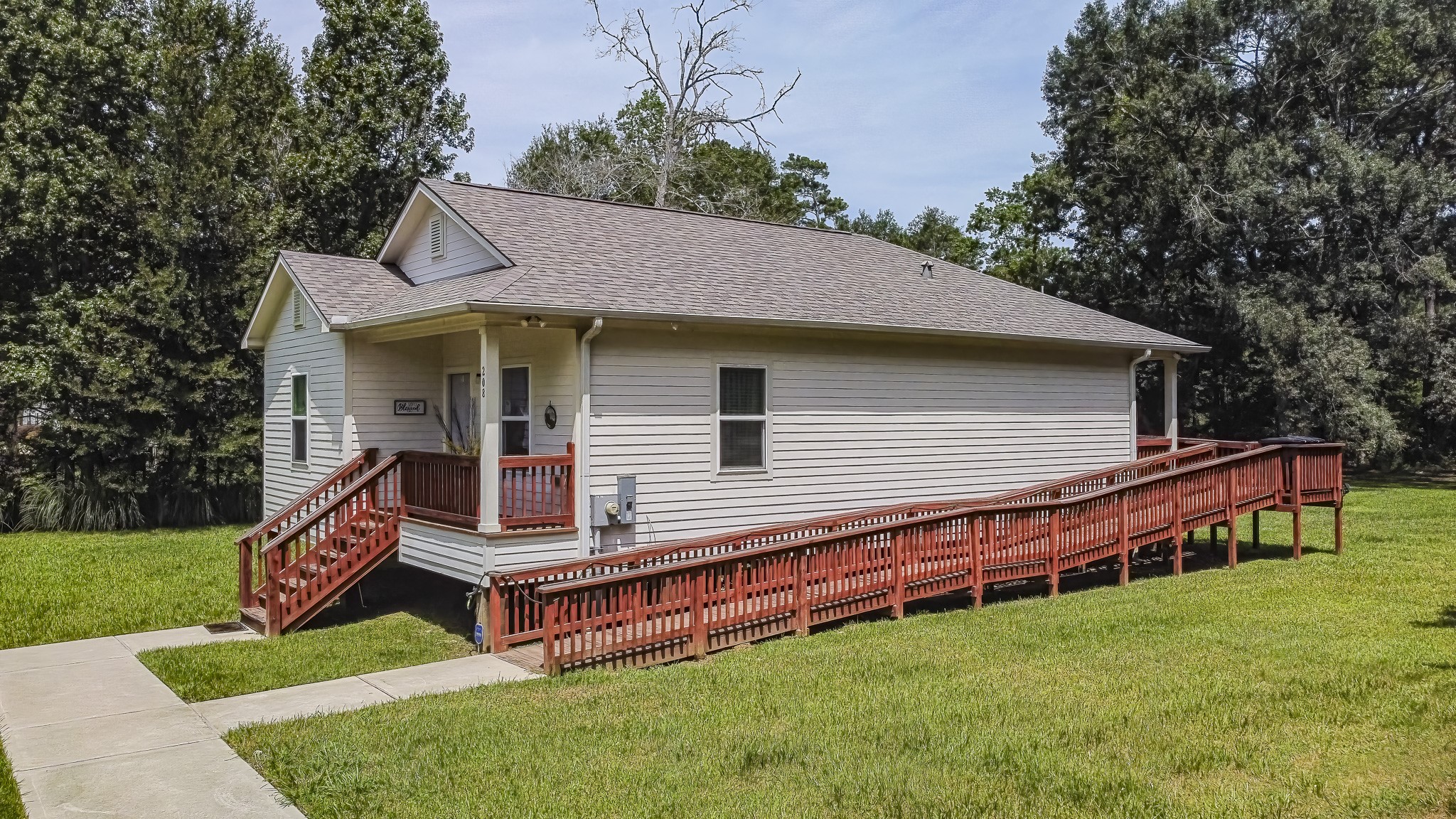 208 County Road 308 Cleveland, TX 77327 - Photo 26 of 32 a backyard of a house with wooden floor and fence