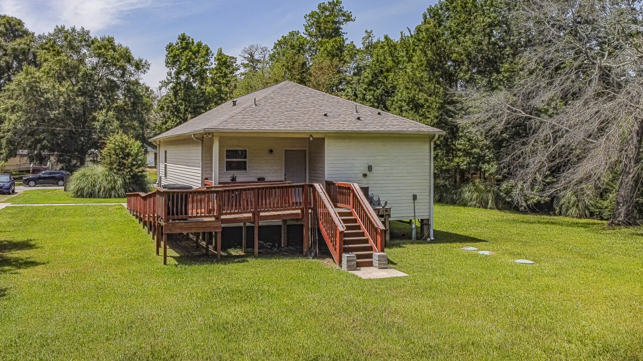 208 County Road 308 Cleveland, TX 77327 - Photo 28 of 32 a front view of a house with garden