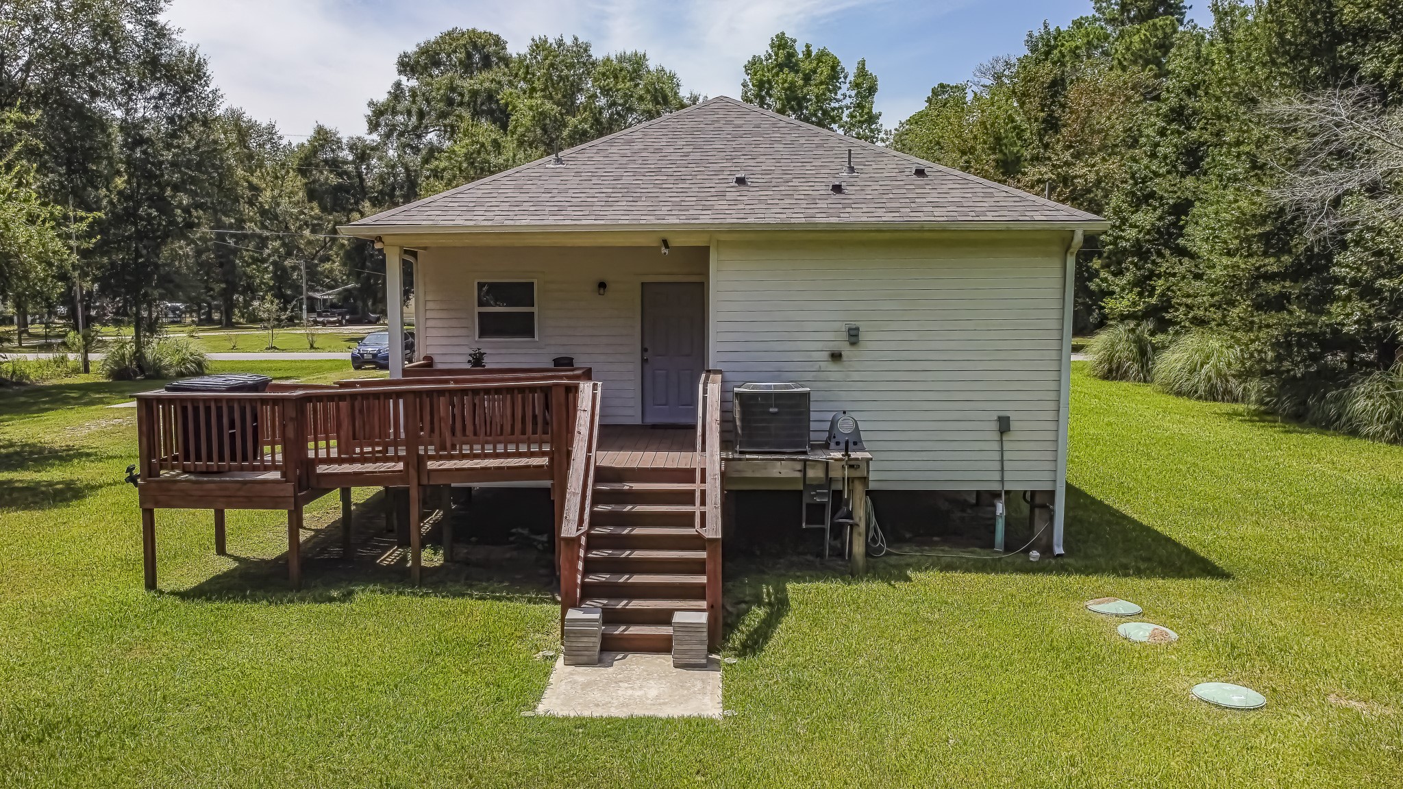 208 County Road 308 Cleveland, TX 77327 - Photo 29 of 32 a view of a house with backyard porch and sitting area
