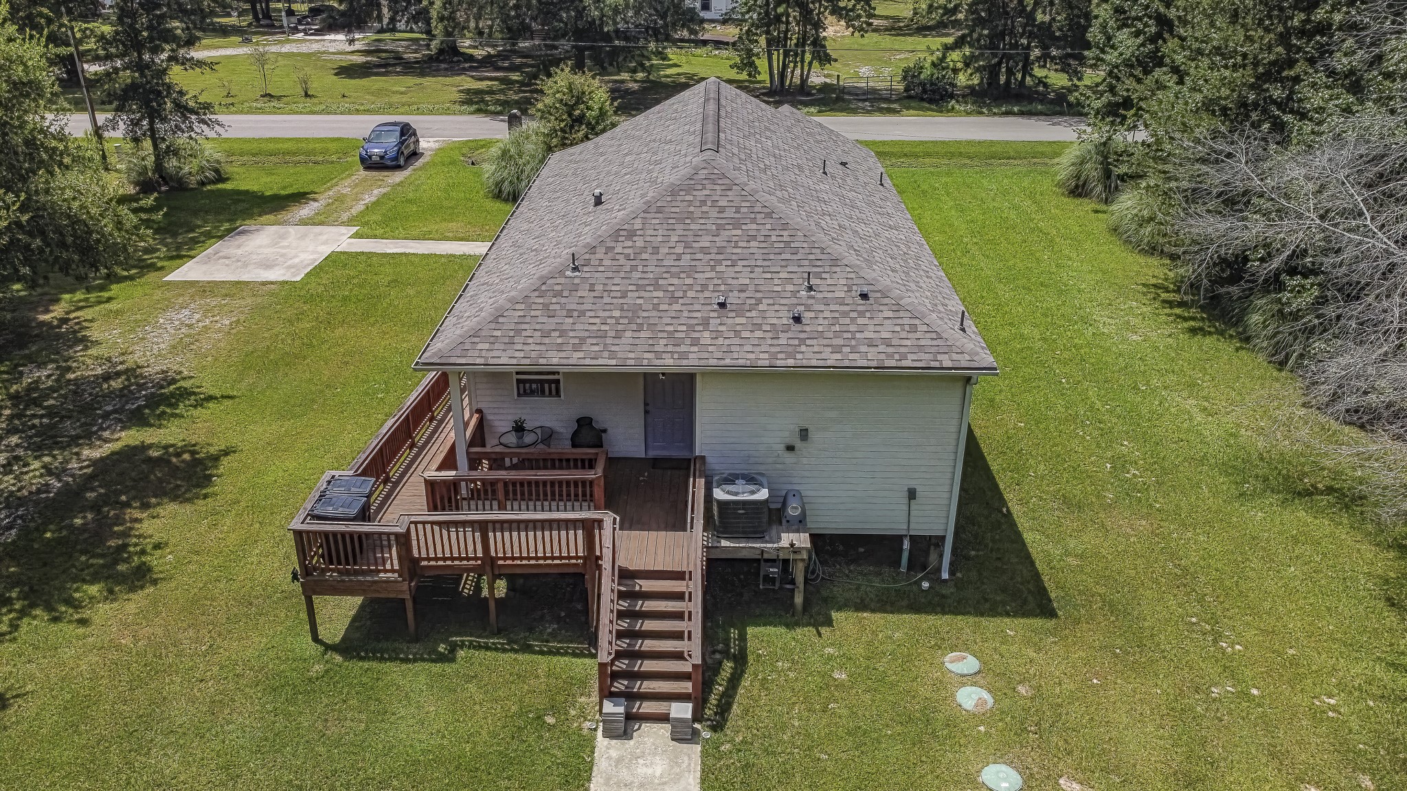 208 County Road 308 Cleveland, TX 77327 - Photo 30 of 32 an aerial view of a house with a yard table and chairs