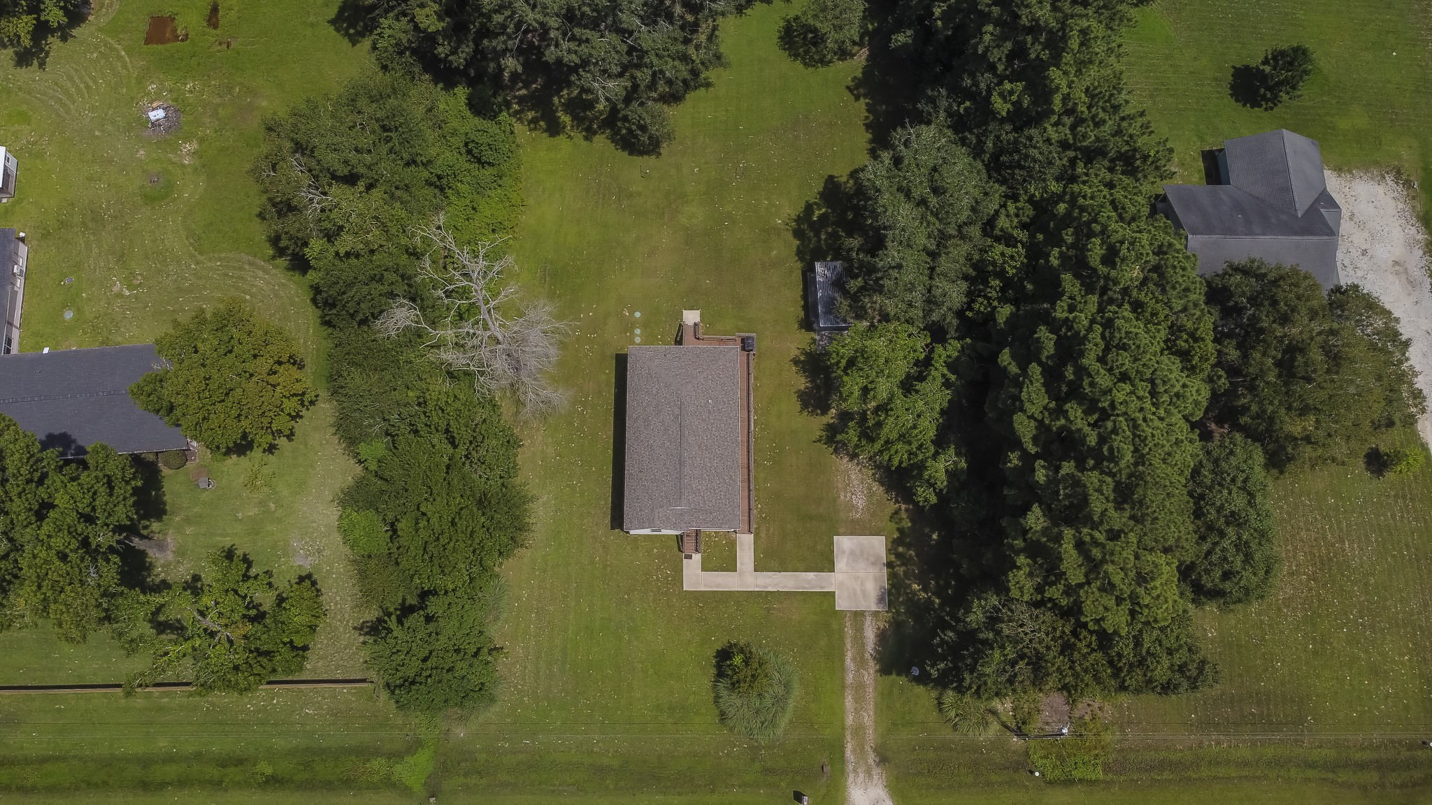 208 County Road 308 Cleveland, TX 77327 - Photo 31 of 32 an aerial view of a residential houses with yard