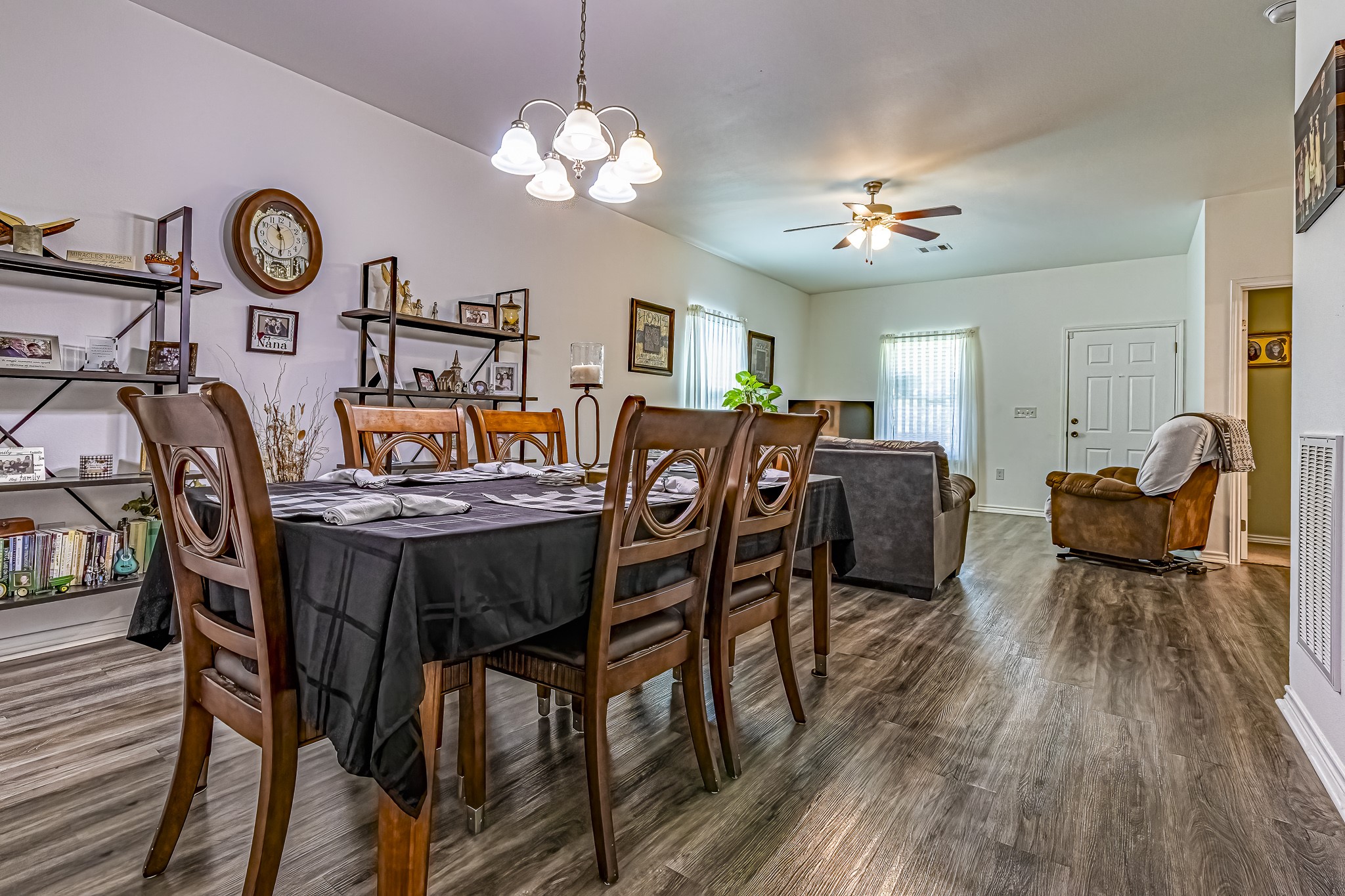 208 County Road 308 Cleveland, TX 77327 - Photo 7 of 32 a view of a dining room with furniture a chandelier and wooden floor