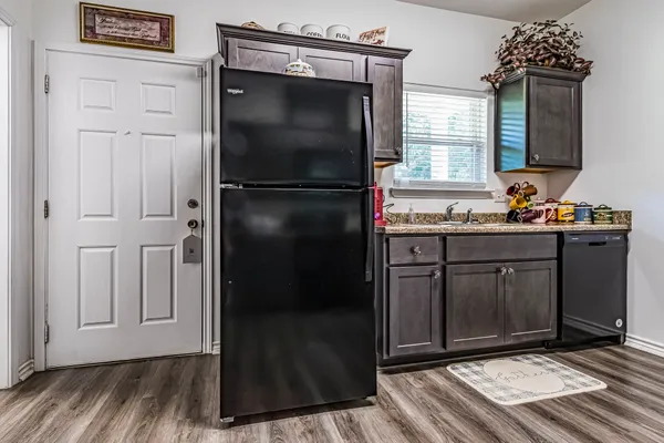 a kitchen with a refrigerator and cabinets