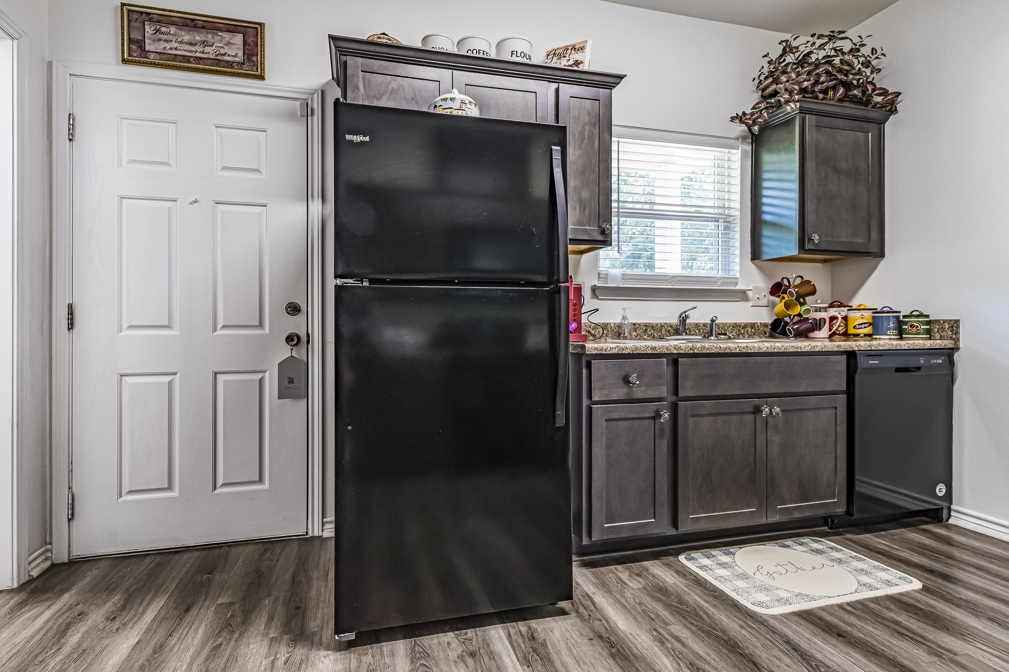 208 County Road 308 Cleveland, TX 77327 - Photo 8 of 32 a kitchen with a refrigerator and cabinets