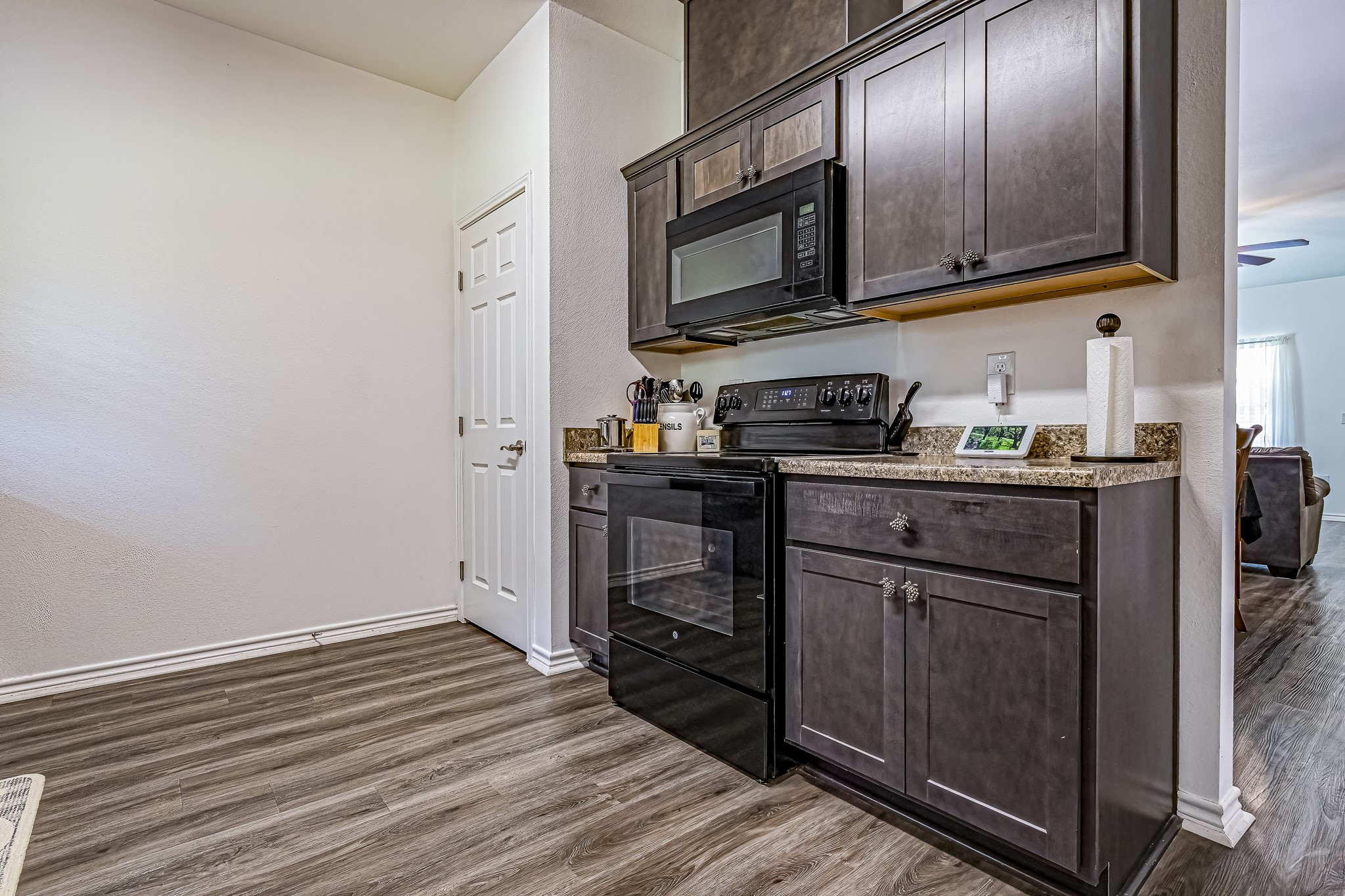 208 County Road 308 Cleveland, TX 77327 - Photo 9 of 32 a kitchen with stainless steel appliances granite countertop a stove a sink and a refrigerator