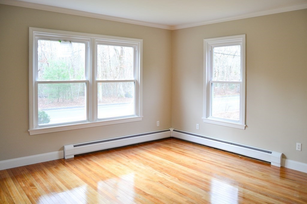 1031 Old Fall River Road Dartmouth, MA 02747 - Photo 18 of 32 a view of an empty room with wooden floor and a window
