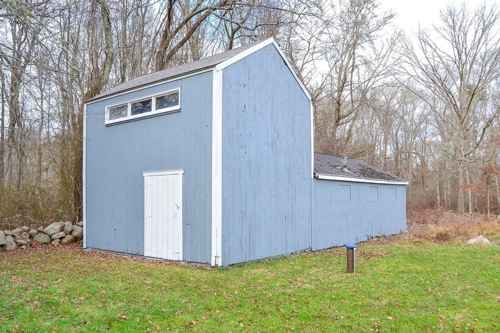 1031 Old Fall River Road Dartmouth, MA 02747 - Photo 19 of 32 a backyard of a house with lawn chairs and a large tree