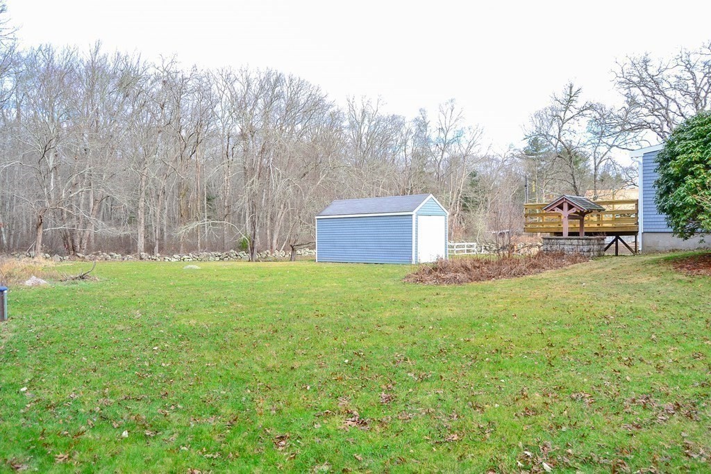 1031 Old Fall River Road Dartmouth, MA 02747 - Photo 20 of 32 a backyard of a house with table and chairs