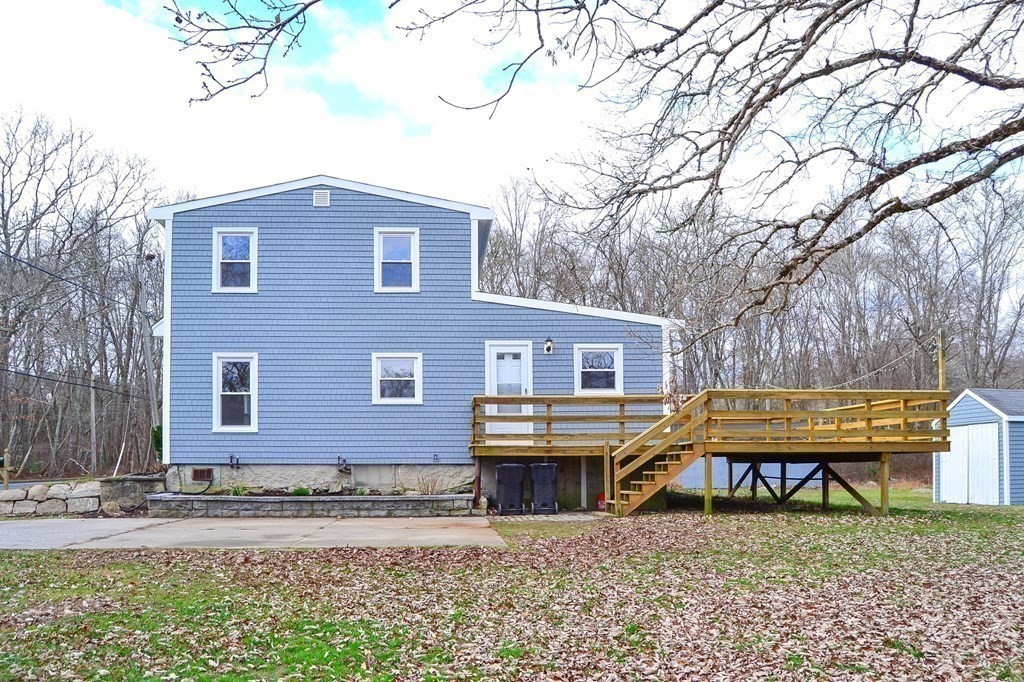 1031 Old Fall River Road Dartmouth, MA 02747 - Photo 23 of 32 a view of a house with a yard and large tree