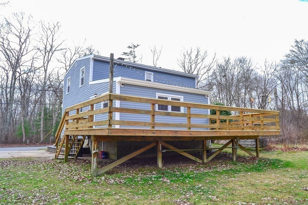 1031 Old Fall River Road Dartmouth, MA 02747 - Photo 24 of 32 a view of a chairs setting on the deck in front of a house