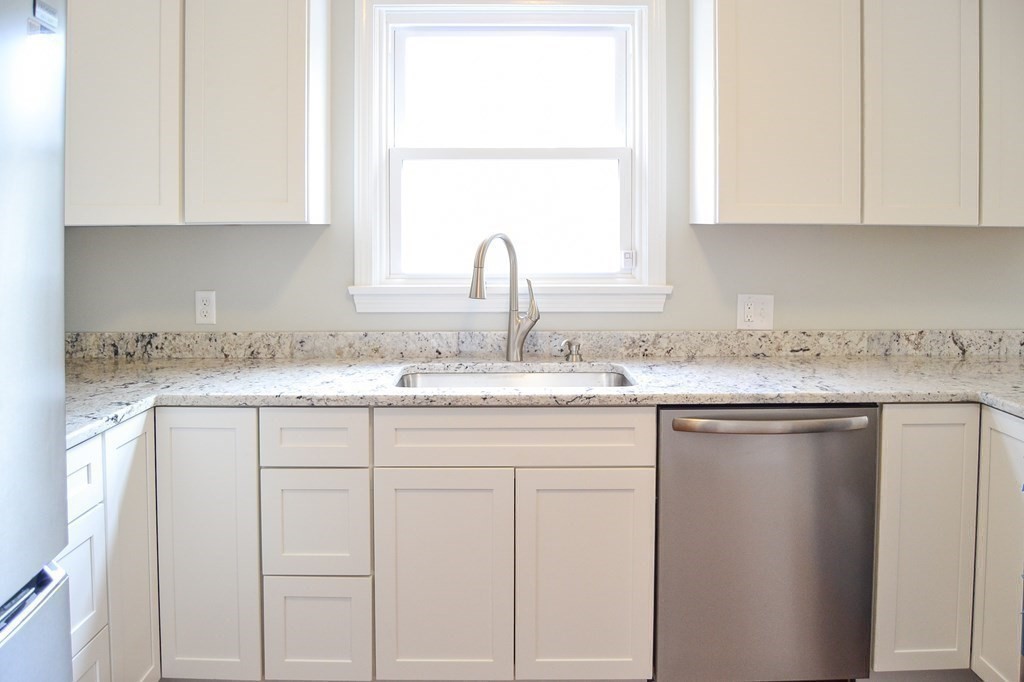 1031 Old Fall River Road Dartmouth, MA 02747 - Photo 4 of 32 a kitchen with granite countertop white cabinets and a sink