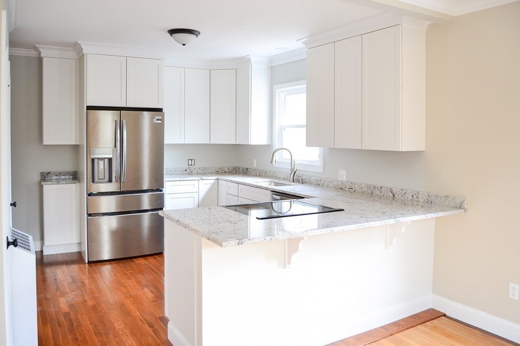 1031 Old Fall River Road Dartmouth, MA 02747 - Photo 7 of 32 a kitchen with granite countertop a refrigerator and a stove top oven