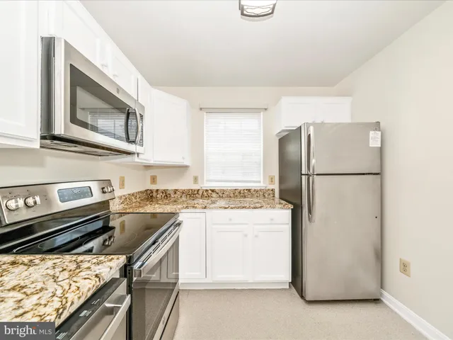 a kitchen with a refrigerator stove and microwave