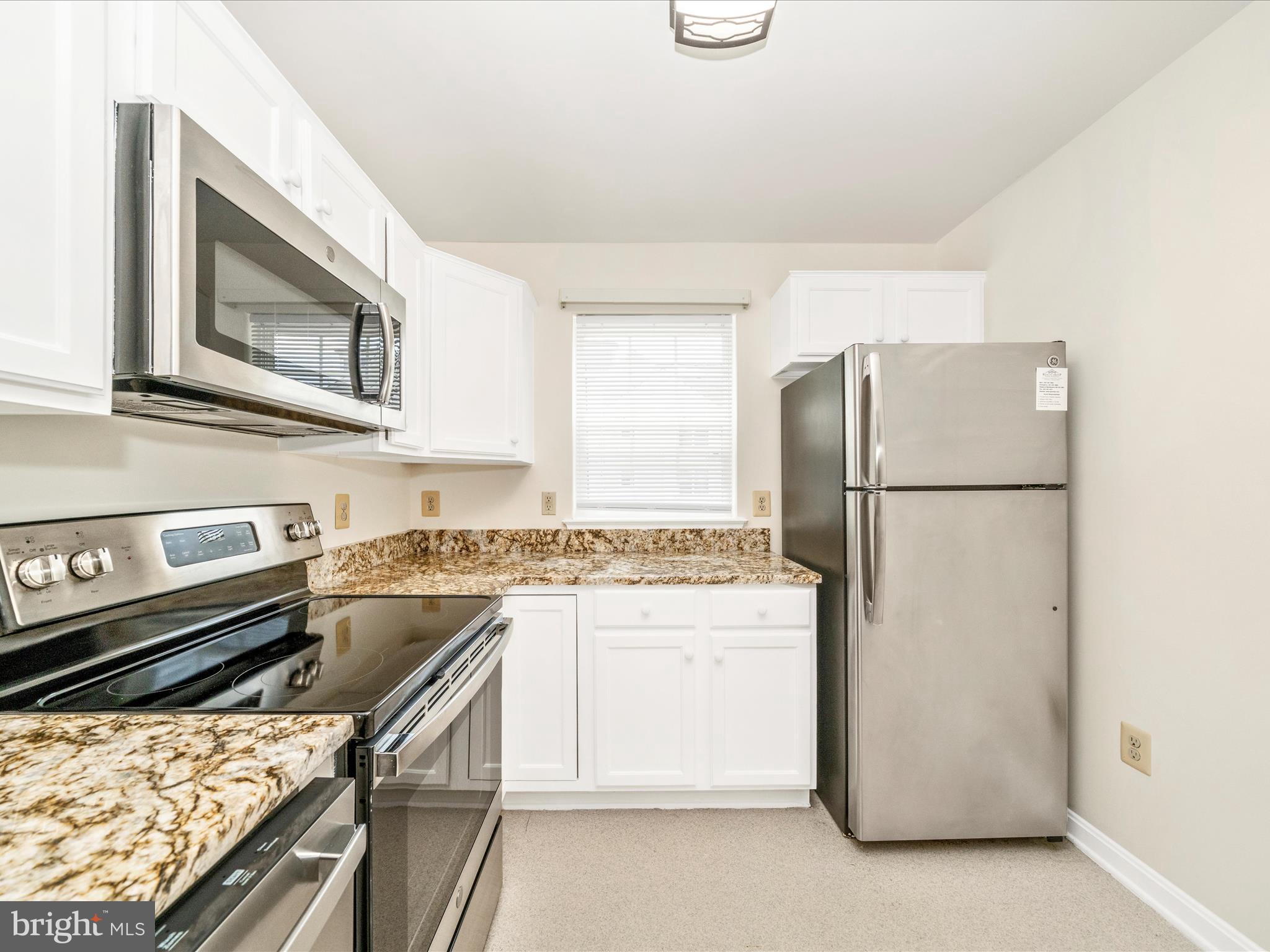 122 Kendrick Place, Unit 24 Gaithersburg, MD 20878 - Photo 16 of 43 a kitchen with a refrigerator stove and microwave
