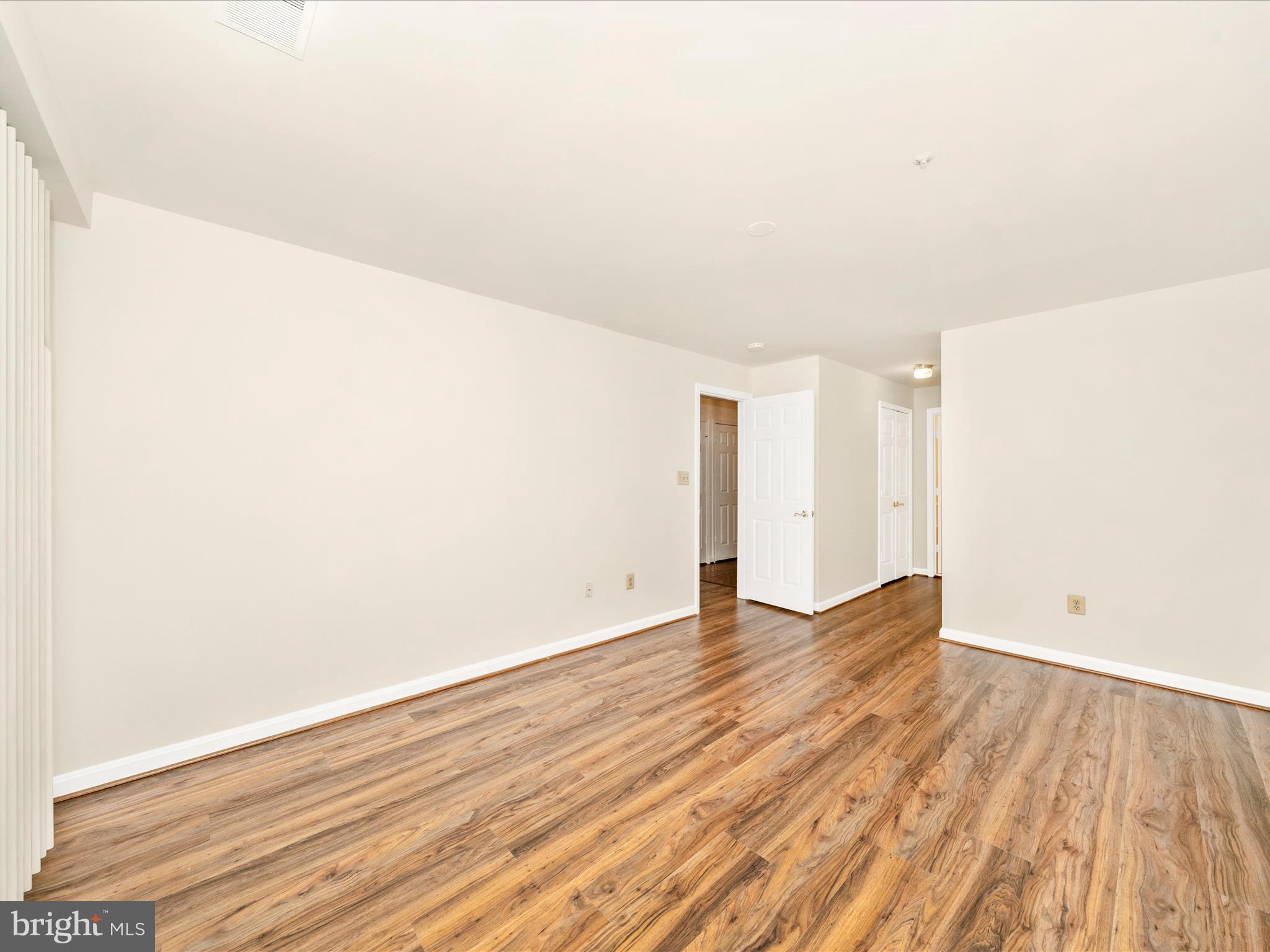 122 Kendrick Place, Unit 24 Gaithersburg, MD 20878 - Photo 22 of 43 a view of an empty room with wooden floor