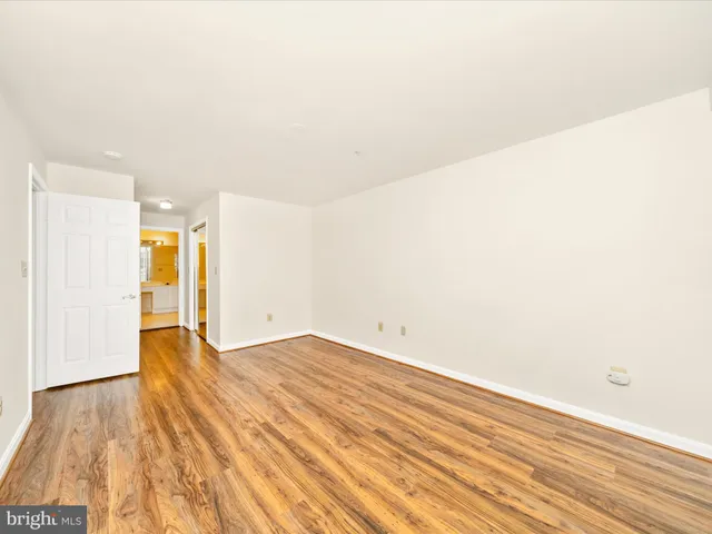 a view of an empty room and wooden floor