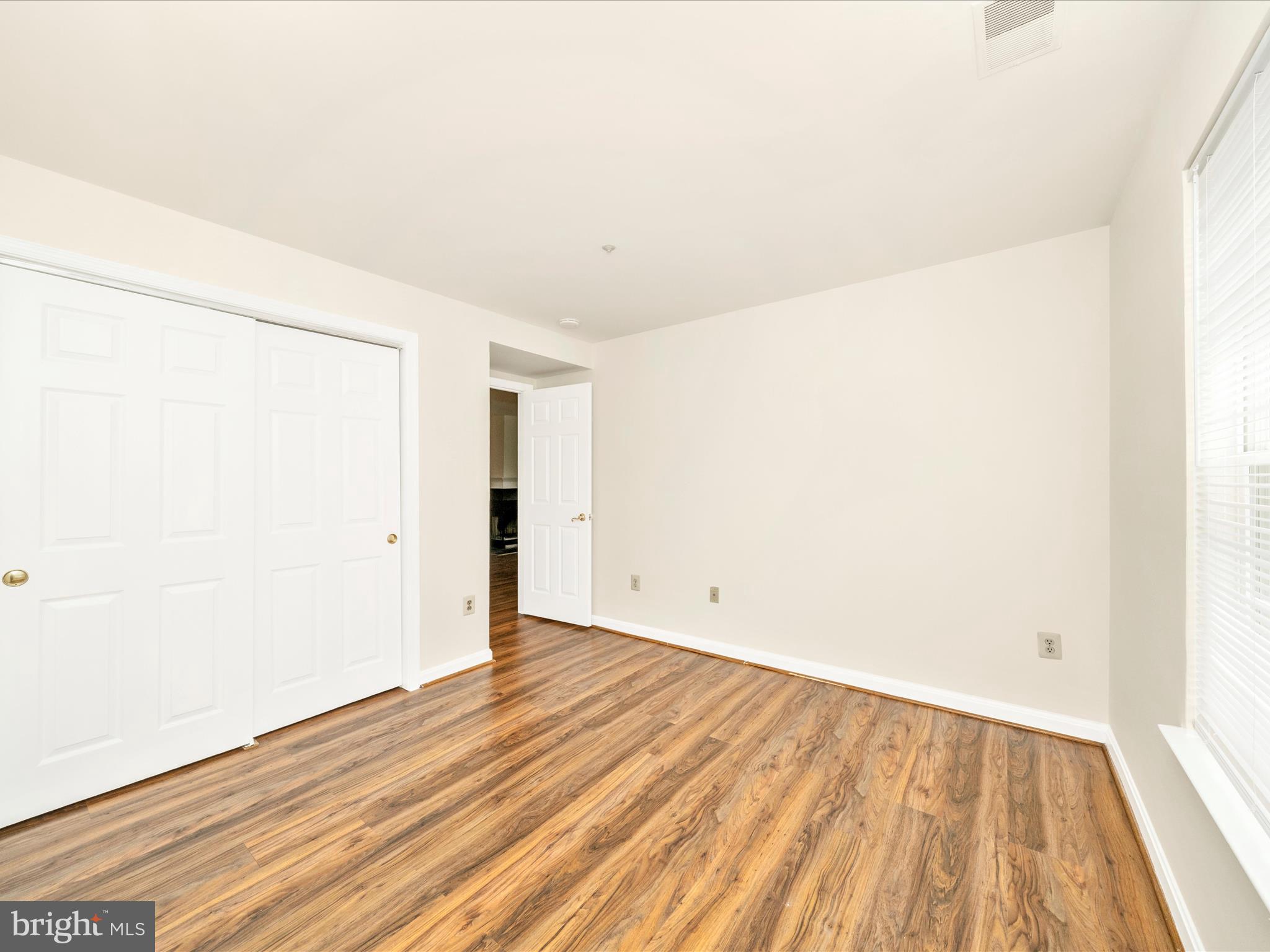 122 Kendrick Place, Unit 24 Gaithersburg, MD 20878 - Photo 29 of 43 a view of an empty room with wooden floor