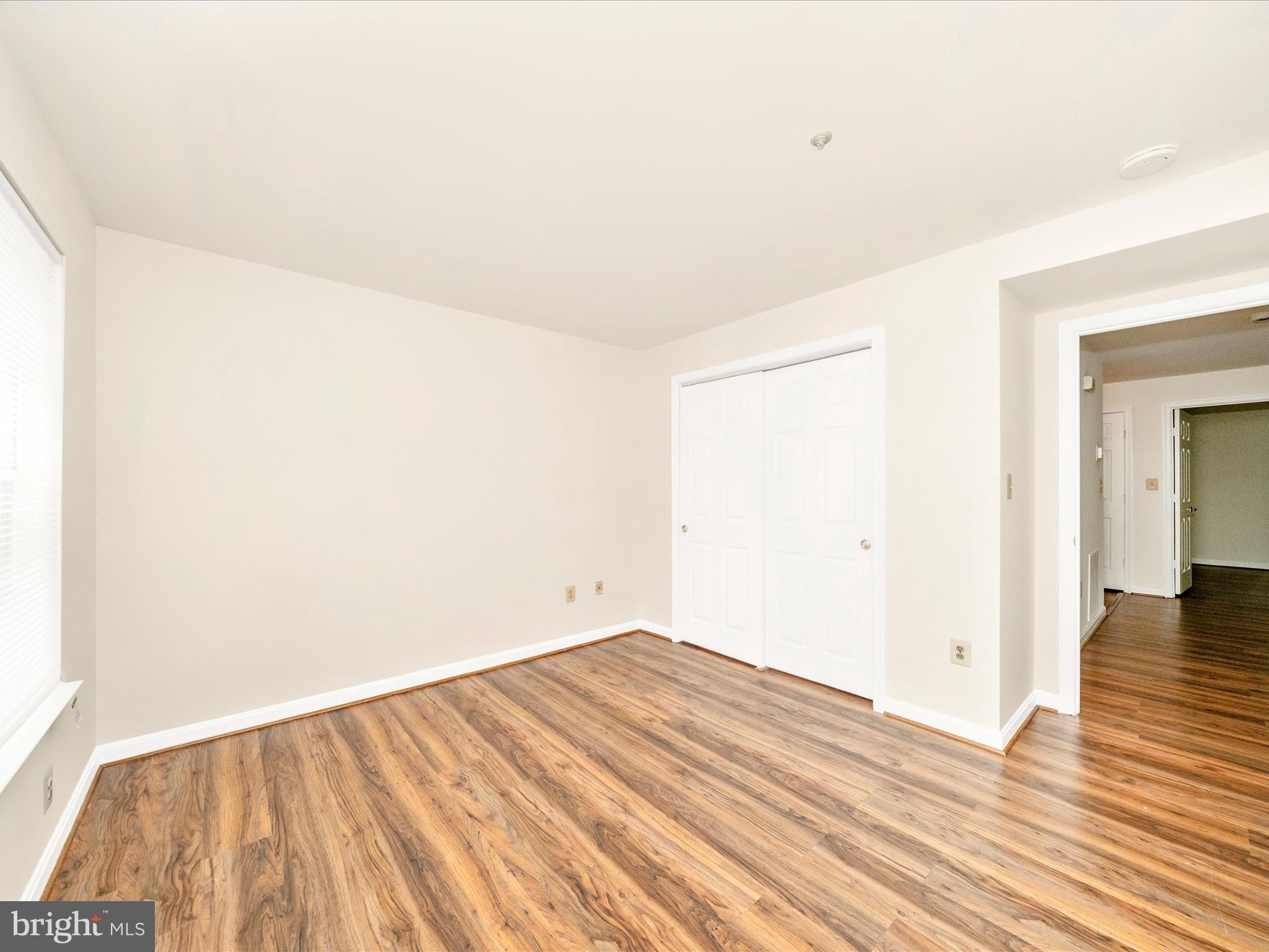 122 Kendrick Place, Unit 24 Gaithersburg, MD 20878 - Photo 30 of 43 a view of an empty room with wooden floor