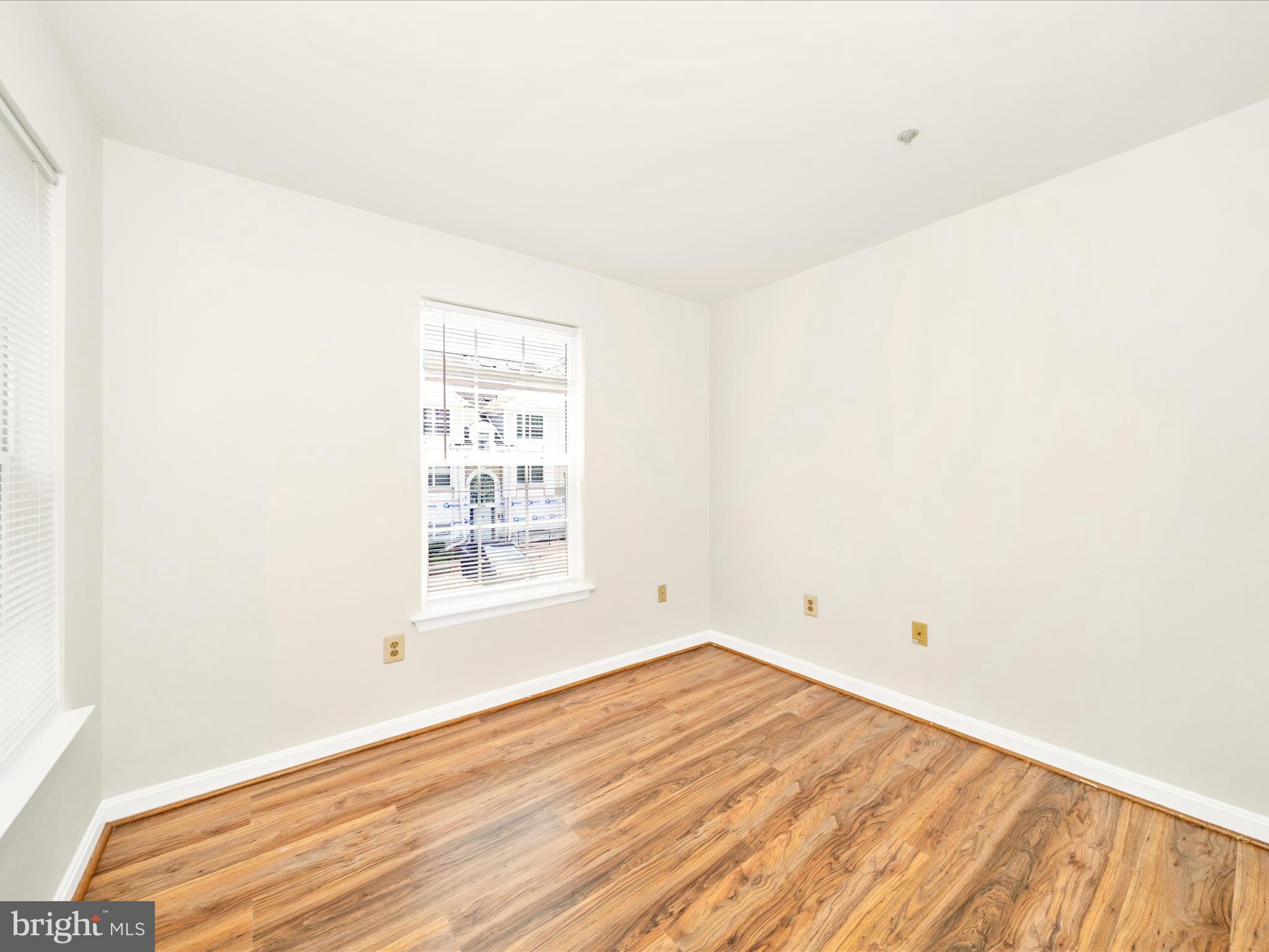 122 Kendrick Place, Unit 24 Gaithersburg, MD 20878 - Photo 35 of 43 an empty room with wooden floor and windows