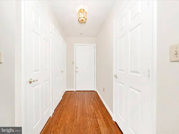 a view of a hallway with wooden floor