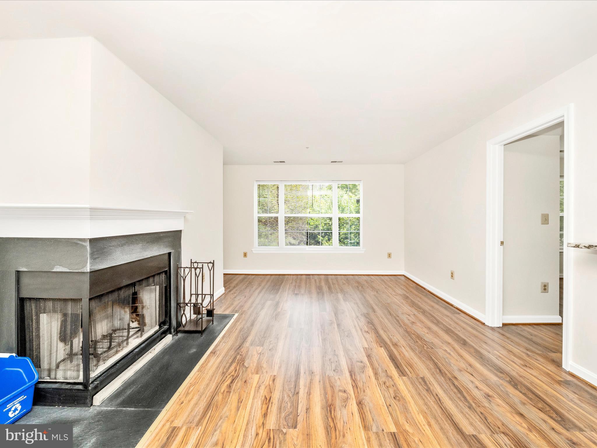 122 Kendrick Place, Unit 24 Gaithersburg, MD 20878 - Photo 7 of 43 an empty room with wooden floor fireplace and windows