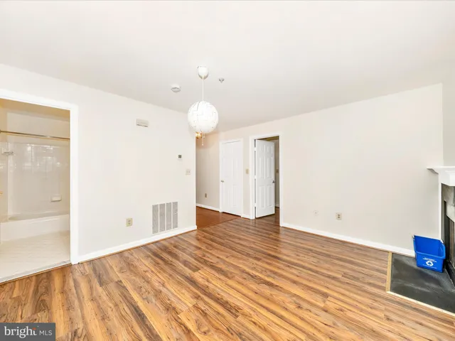 a view of an empty room and wooden floor